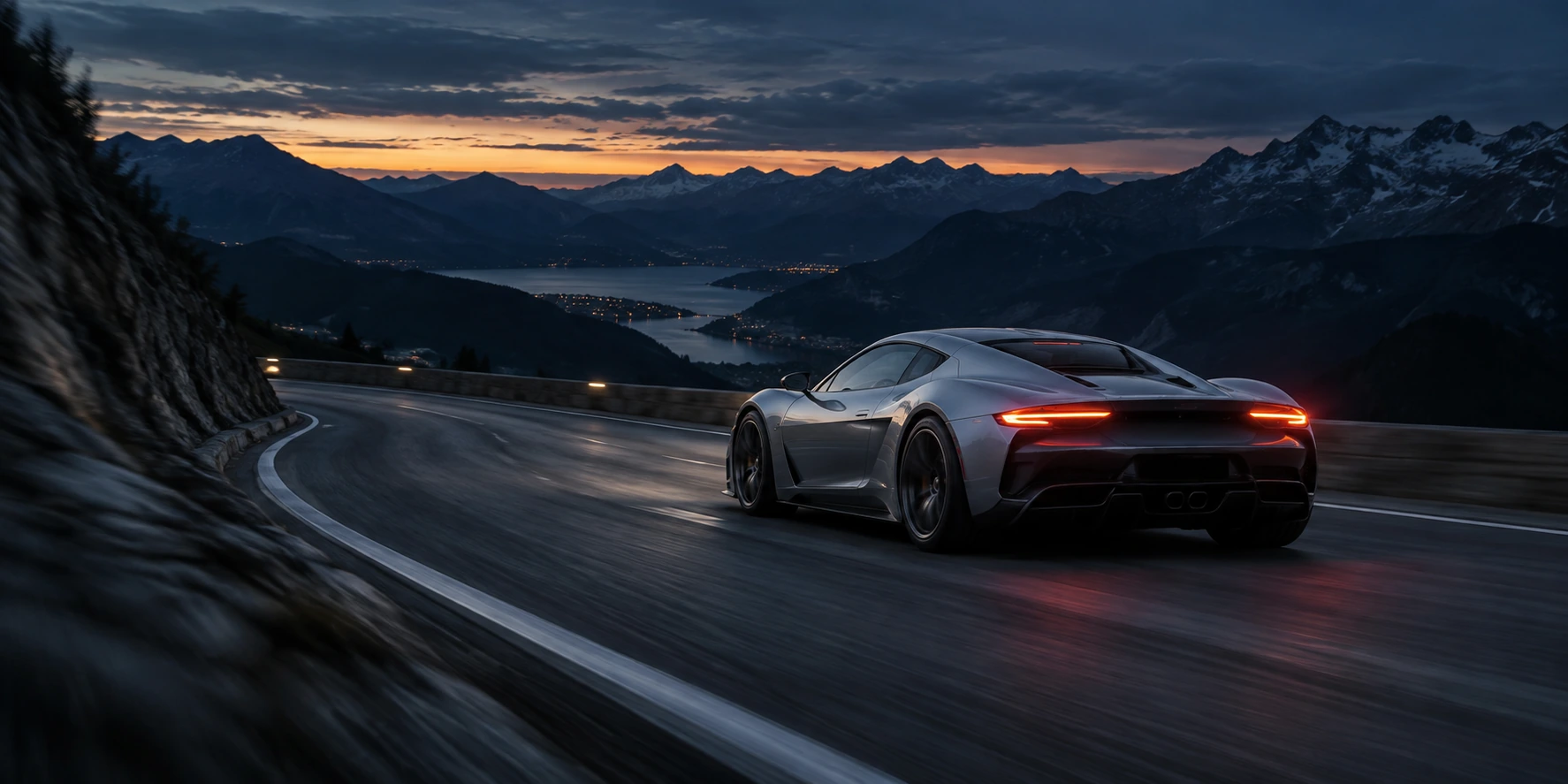 A silver performance car taking a sweeping mountain-road corner at blue hour